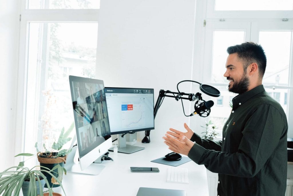 Man leading a webinar to a live audience. Image Credit: Unsplash